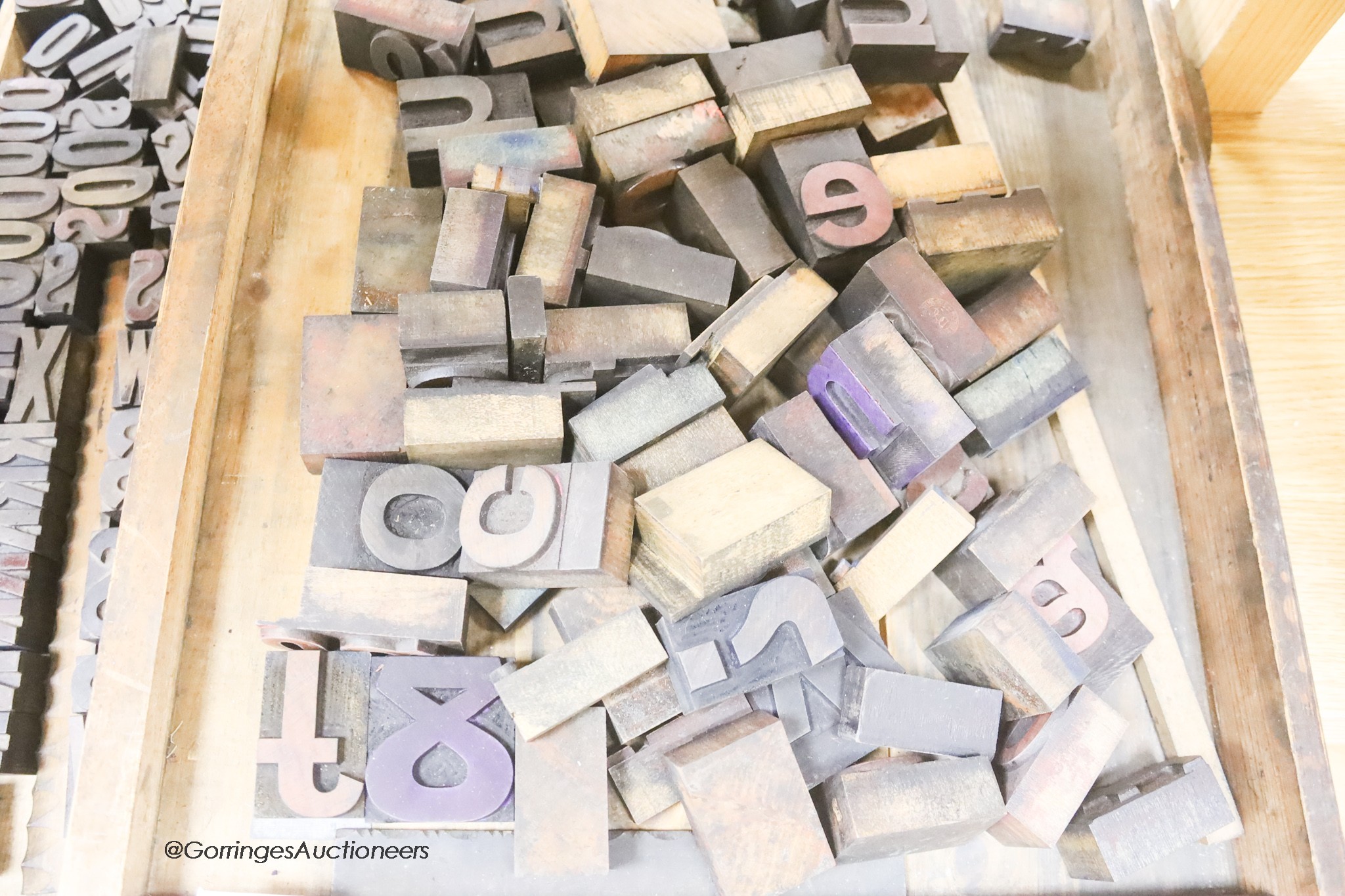 Three trays of printing blocks and letters two other patterned printing blocks and a large brass model of the letter b